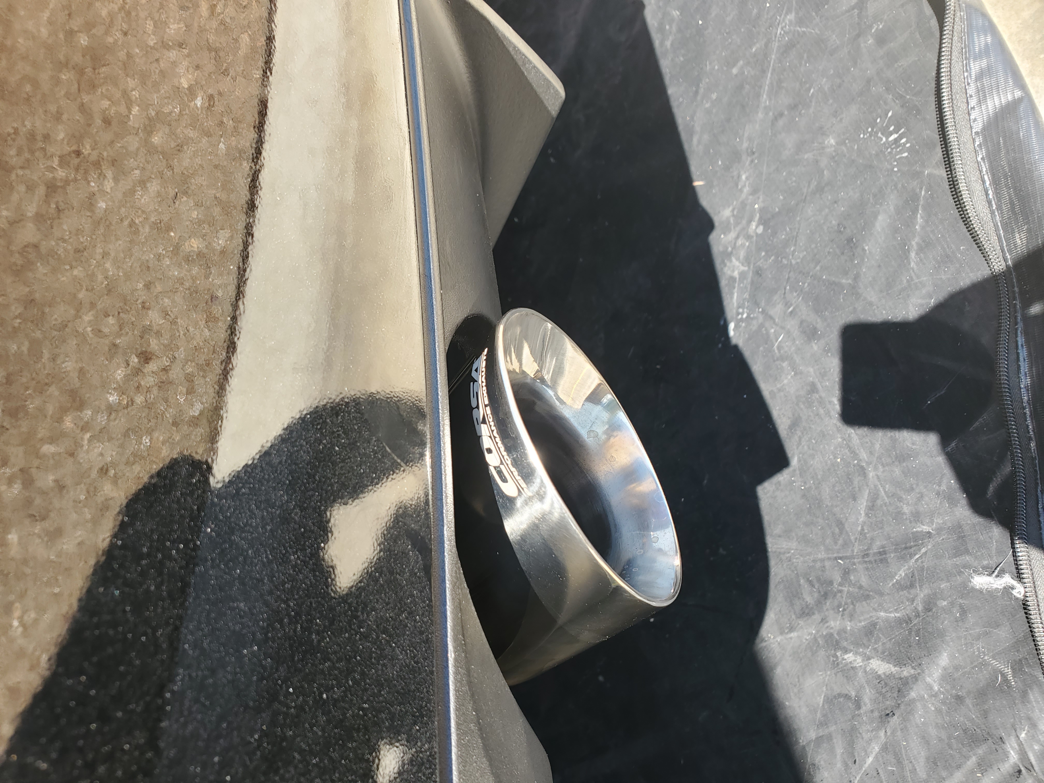 Close-up of installed Corsa tip — driver side