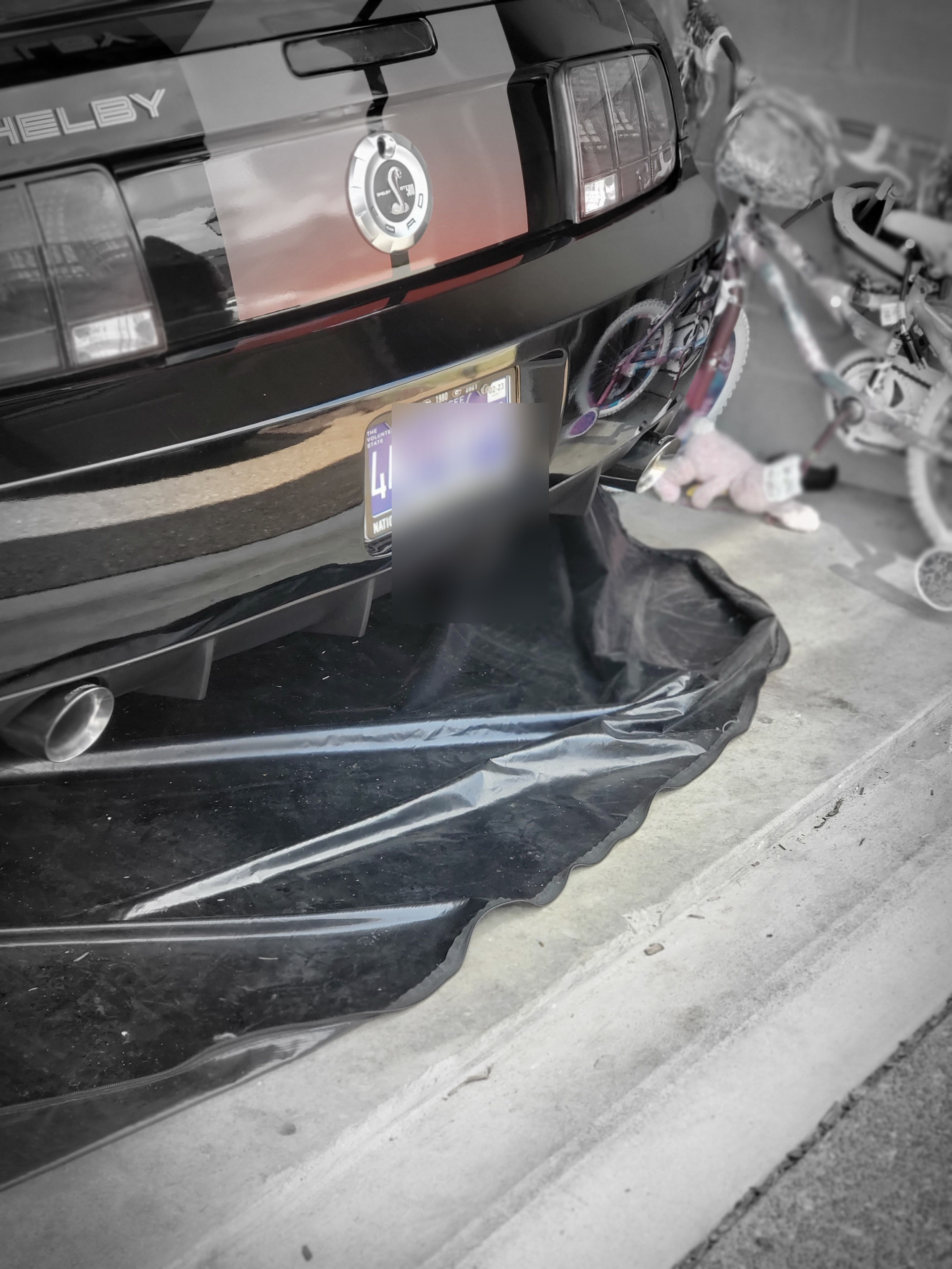 Wider rear shot in the garage with stock exhaust tips