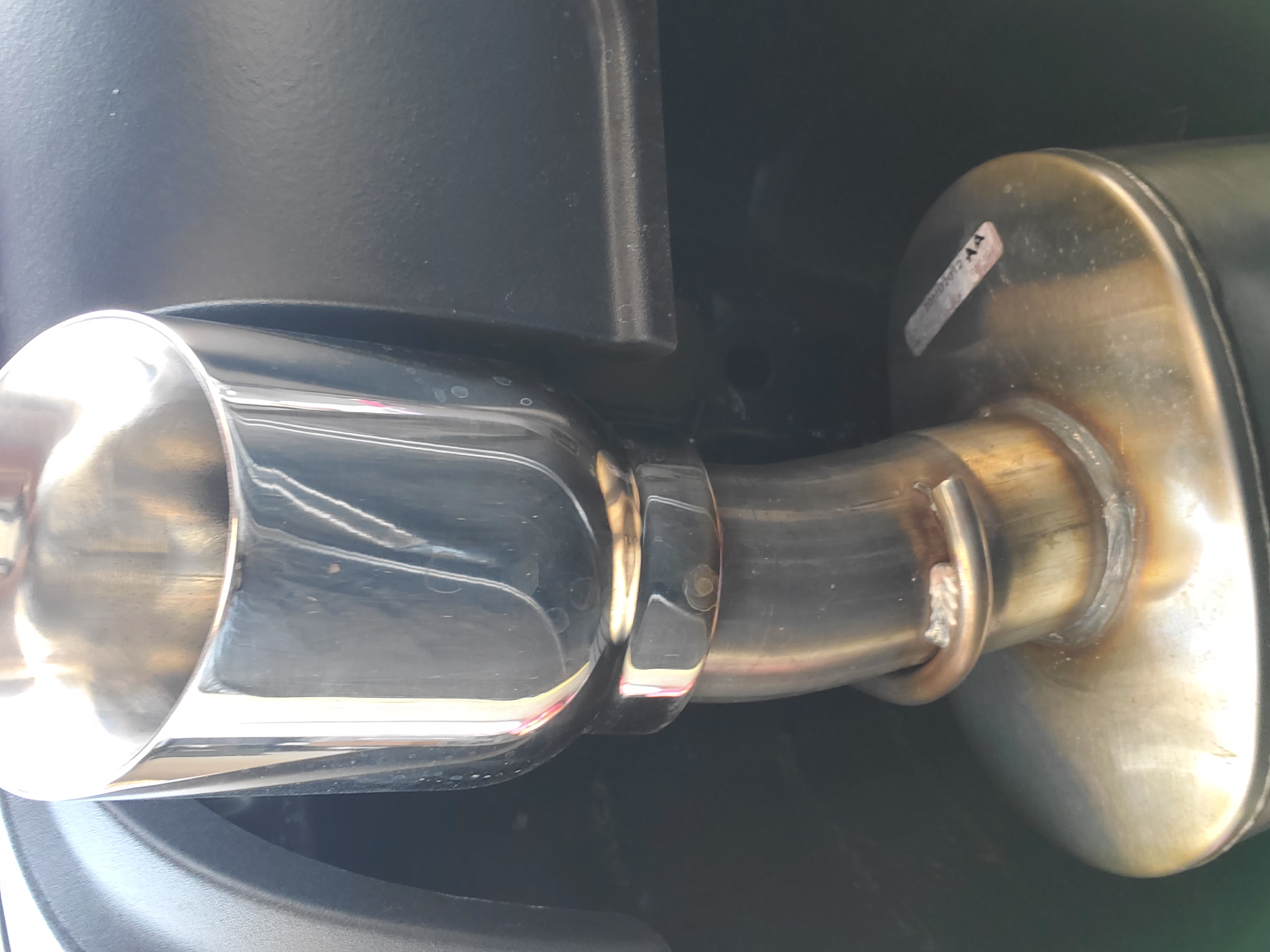 Corsa muffler assembly close-up showing weld quality